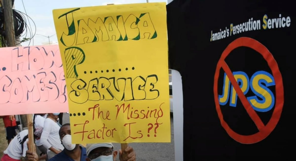 Protesters with placards outside the Jamaica Public Service Company's corporate offices in New Kingston.