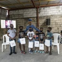 Marcy-does-a-photo-op-with-the-children-who-were-gifted-with-tablets-scaled